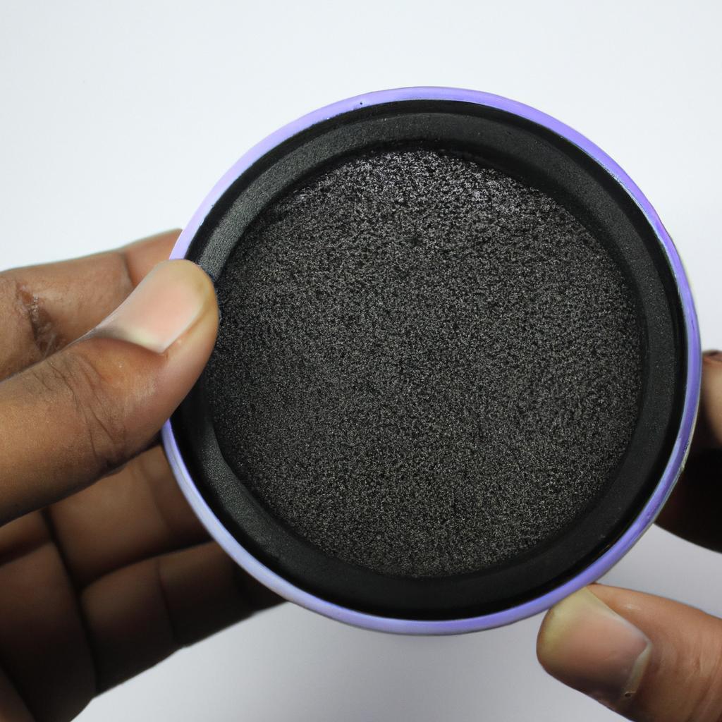 Person holding activated carbon filter