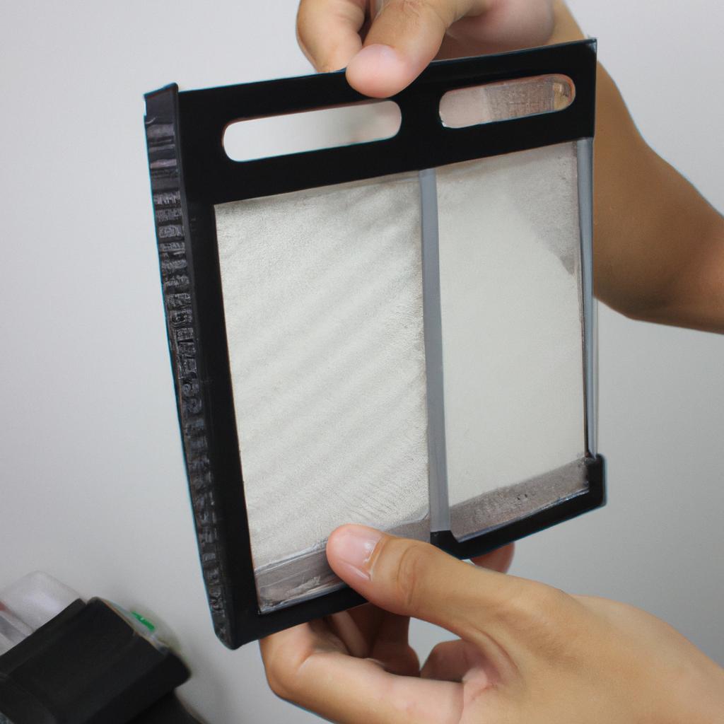 Person holding HEPA filter demonstration